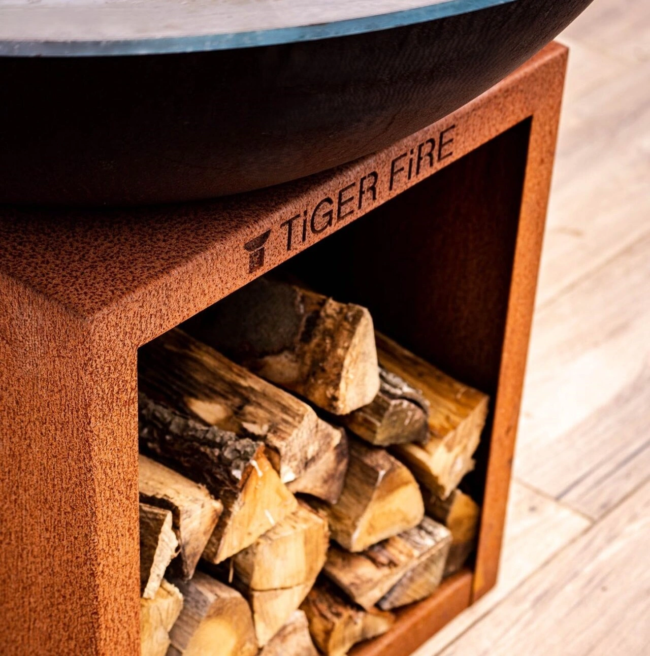 Een plancha bbq van cortenstaal met houtopslag. TIGER FIRE OFFICIAL STORE | TIGER FIRE SHOP | TIGER FIRE | PLANCHA BBQ | BBQ KOPEN | Kupić BBQ | Koupit BBQ | Buy a BBQ | Acheter BBQ | BBQ KAUFEN | Acquistare un BBQ | Comprar un BBQ | EINEN BBQ KAUFEN | Comprar um BBQ | FUERPLATTE PLANCHA BBQ | PLANCHA GRILL | BBQ GRIDDLE